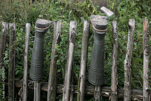 Old boots on the wooden fence at country side.