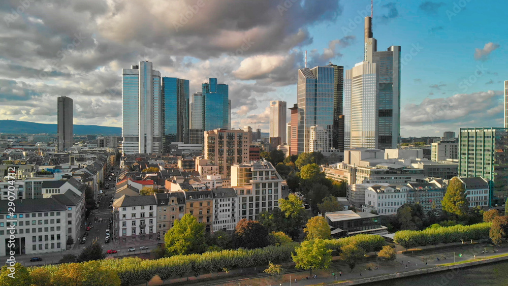 Aerial flying along the futuristic skyline the business and financial centre of Frankfurt am Main, sunset view from drone