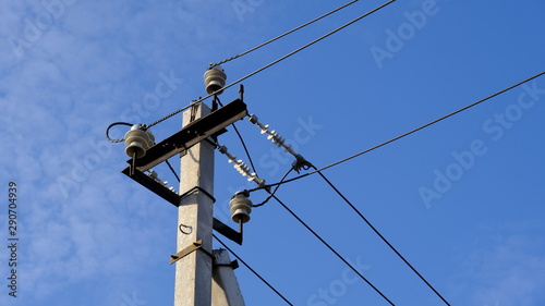  Electric pole with wires against the blue sky