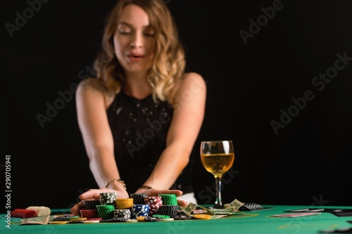 A girl raises bets with chips in a casino. Focus on chips, background for the gaming business.
