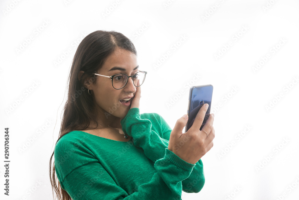 Portrait of a super cheerful and excited girl when she sees a message Portrait of a super cheerful and excited girl when she sees a message