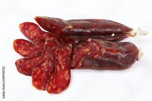 Horse sausage. Photo on a white background. Whole and sliced sausage. View from above. Isolated object