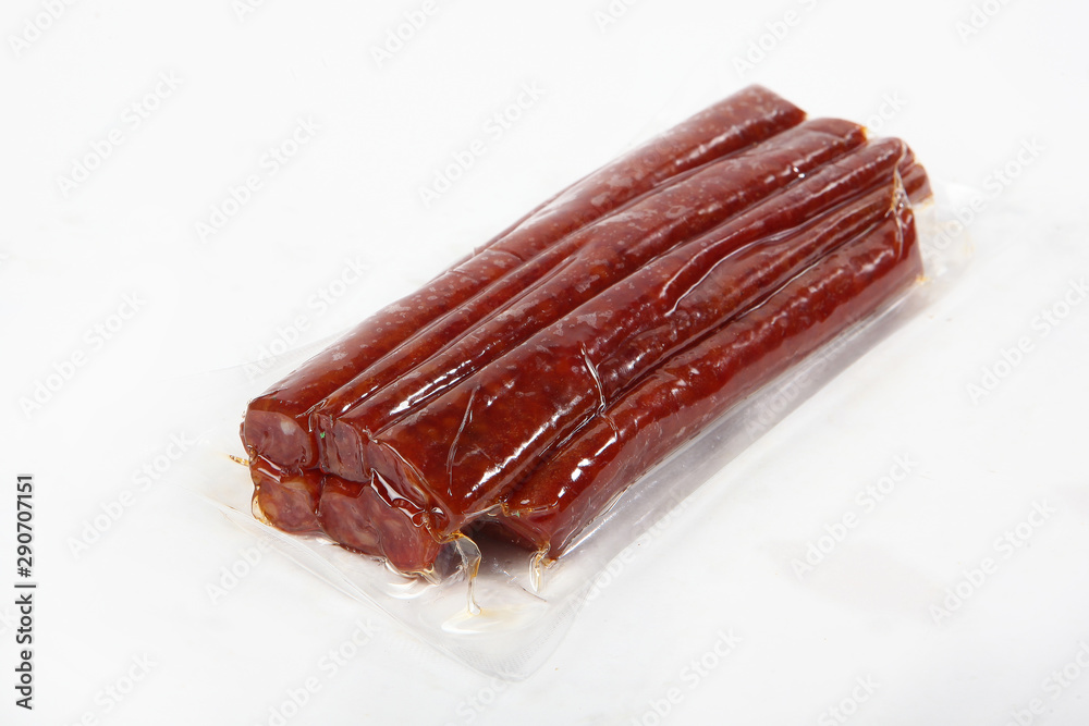 Sun-dried vacuum-packed sausage. View from above. Isolated object. Copy space. Sun-dried vacuum-packed sausage. View from above. Isolated object. Copy space.