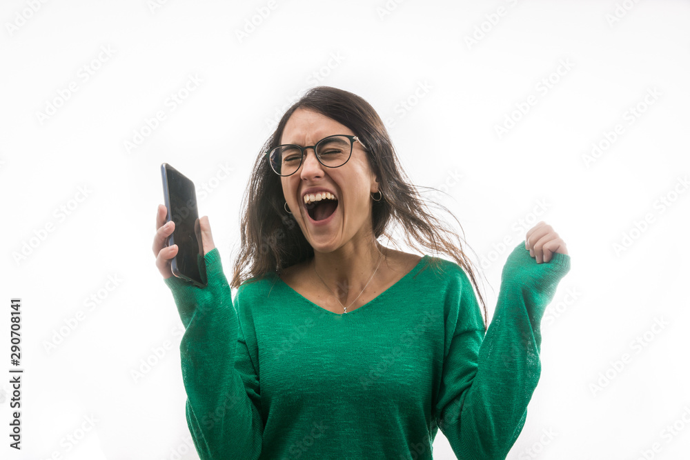 Naklejka premium Portrait of a super cheerful and excited girl when she sees a message