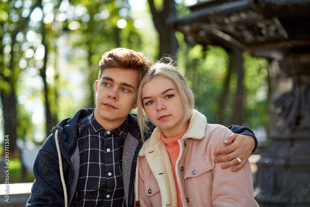 Girlfriend and Boyfriend falling in love, sitting and dreaming in Park near fountain in fall. Concept of love and happiness Girlfriend and Boyfriend falling in love, sitting and dreaming in Park near fountain in fall. Concept of love and happiness