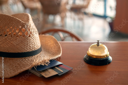 Hotel lobbym Chekin. Straw hat, passport, bank cards. photo