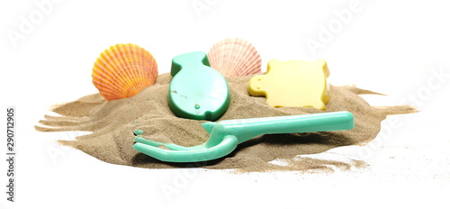 Beach toys for kids, plastic tools in sand pile with seashells isolated on white background