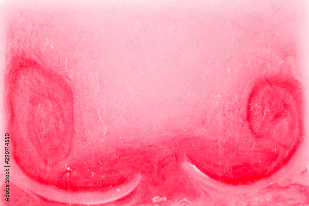 Close-up, shallow focus of a bar of natural soap with engraved letters on its side.