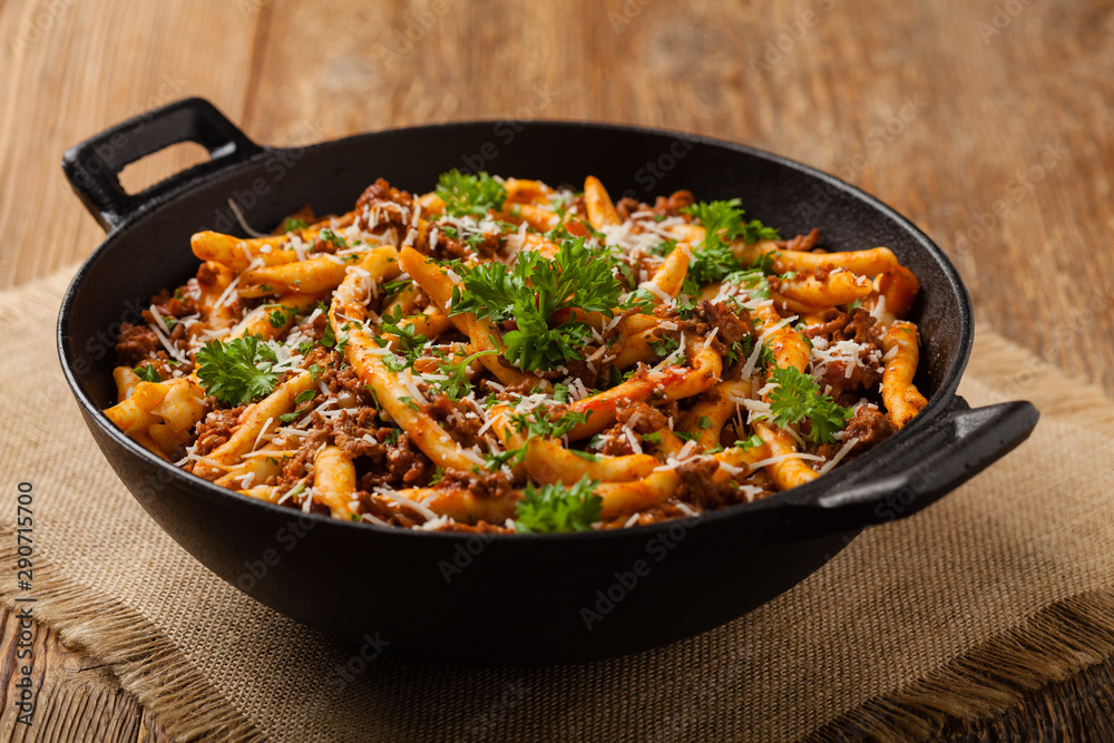 Maccheroni al ferretto with beef in ragu bolognese. Front view. Maccheroni al ferretto with beef in ragu bolognese. Front view.
