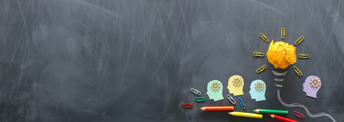 Education concept image. Creative idea and innovation. Crumpled paper as light bulb metaphor over blackboard
