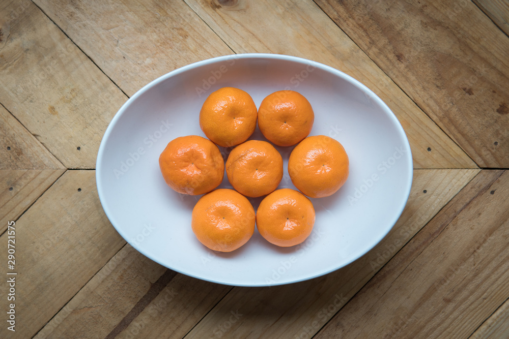 fresh and ripe orange mandarins in a white plate fresh and ripe orange mandarins in a white plate