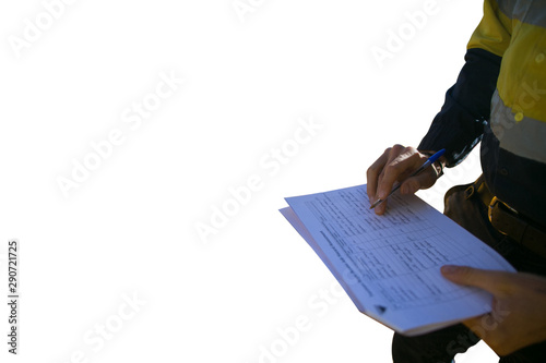 Miner supervisor checking reviewing document before issued sigh of working at height permit JSA risk assessment on site prior to performing high risk work isolated white background construction site  photo