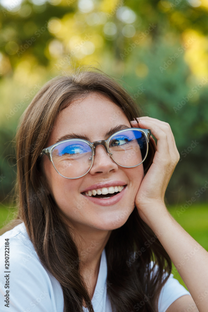 Close up of a smiling pretty girl sitting at the park Close up of a smiling pretty girl sitting at the park