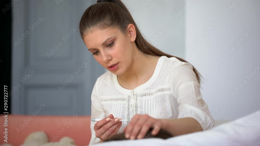 cold flu virus disease, sick kid in bed with thermometer. Sick baby child little boy with high fever lying at sofa home. mother touching head, checking measures temperature and taking care of son, 4 K cold flu virus disease, sick kid in bed with thermometer. Sick baby child little boy with high fever lying at sofa home. mother touching head, checking measures temperature and taking care of son, 4 K
