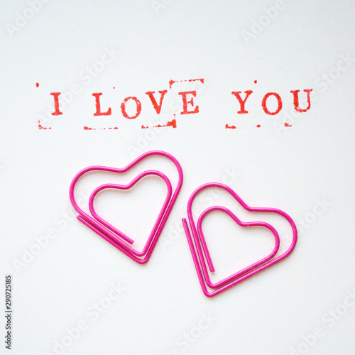 Wallpaper Mural The text I love you in English, typed in stamps, on a white background, decorated with paper clips in the shape of a heart. Postcard square banner concept for valentines day, mothers day Torontodigital.ca