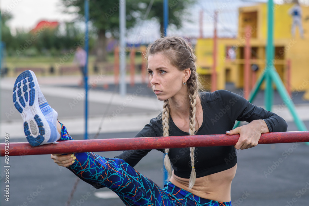 Fototapeta premium Girl stretches on the playground