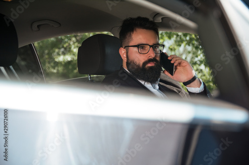 Handsome businessman driving a car