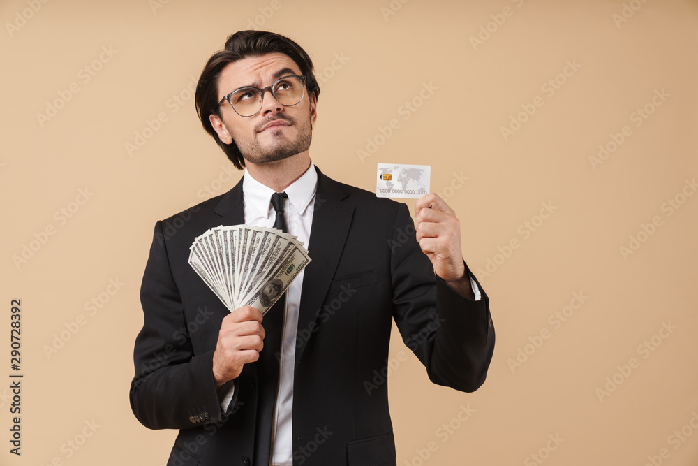 Image of caucasian businessman holding cash money and credit card