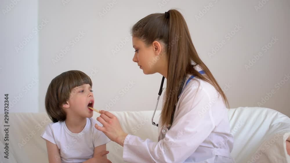 cold flu virus disease, sick kid child. Little boy is with young woman female pediatrician doctor cheking of cute little patient during medical examination in hospital, healthcare, pediatrics, 4 K cold flu virus disease, sick kid child. Little boy is with young woman female pediatrician doctor cheking of cute little patient during medical examination in hospital, healthcare, pediatrics, 4 K