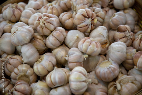 heap of garlic vegetable in market .