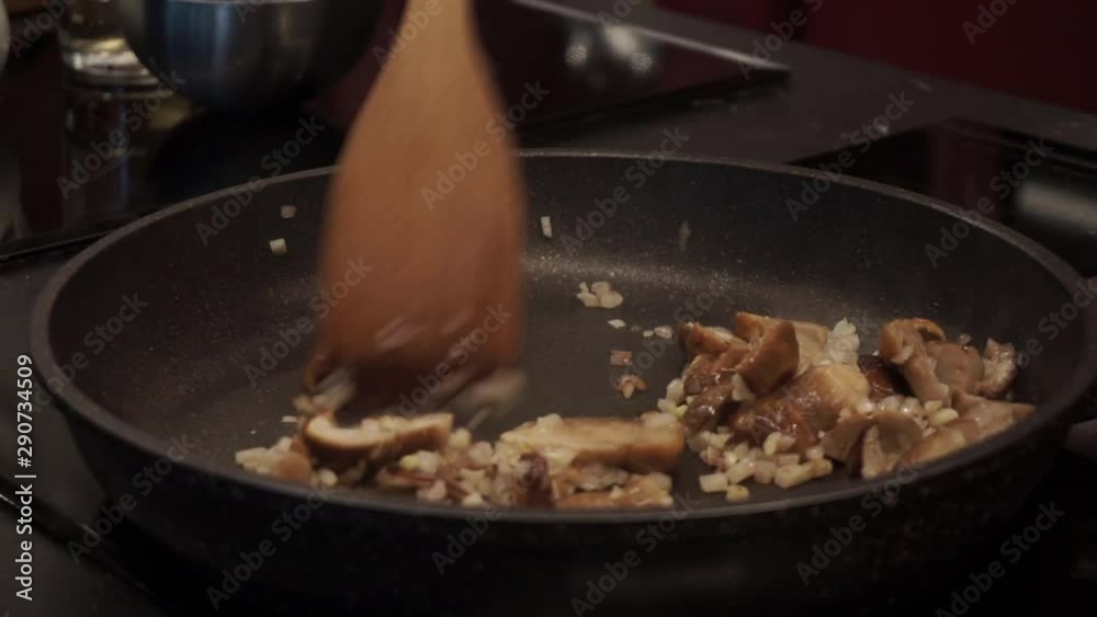 Stir frying mushrooms with garlic and onion. Cooking pasta. Italian cuisine Stir frying mushrooms with garlic and onion. Cooking pasta. Italian cuisine