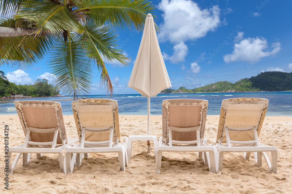 chairs and umbrella on the beach of Seychelles 