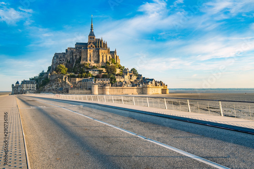 Access road to Mont Saint Michel and its Abbey with the sea at low tide.
