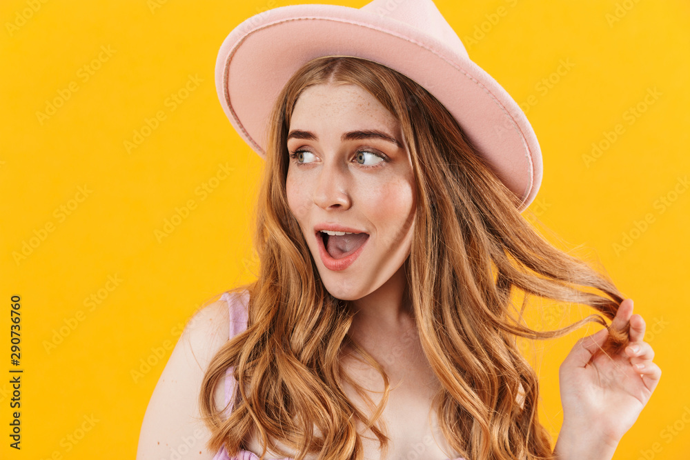Cheerful happy girl isolated over yellow wall background wearing hat. Cheerful happy girl isolated over yellow wall background wearing hat.