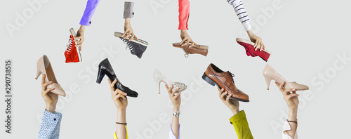 Hands holding different shoes on isolated background