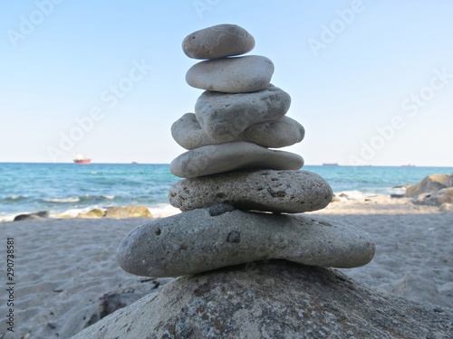 Zen stone stack near the sea. Harmony, balance and simplicity concept. Poise pebbles, zen sculpture, beach stone cairn.