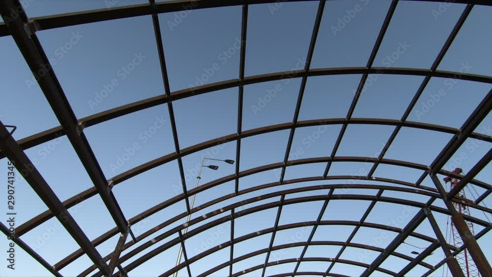 The metal construction of the roof from a metal profile. Close-up. Construction and architecture. Silhouetted metal frame at sunset The metal construction of the roof from a metal profile. Close-up. Construction and architecture. Silhouetted metal frame at sunset
