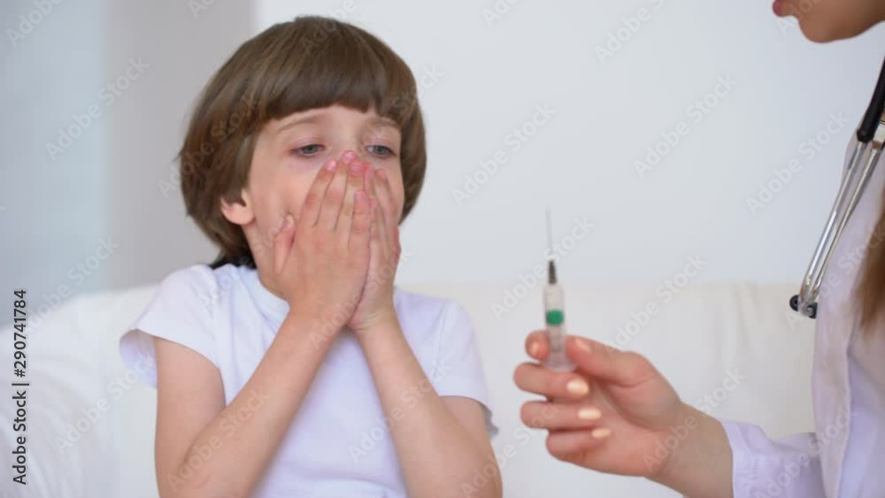 Portrait of child cute little boy afraid of injection. Doctor nurse ...