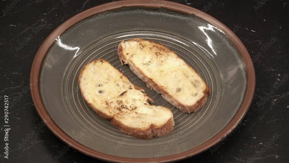 Putting cream cheese on bread. Cooking bruschetta with turkey. Italian cuisine. Above view Putting cream cheese on bread. Cooking bruschetta with turkey. Italian cuisine. Above view