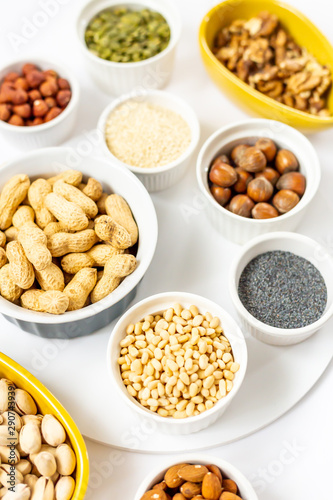 Various Nuts and Seeds on White Background in the Bowls - Image