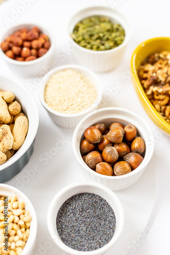 Various Nuts and Seeds on White Background in the Bowls - Image