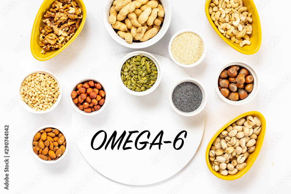 Top View of Variety of Nuts and Seeds on the White Background with Omega-6 Text Copy - obrazy, fototapety, plakaty 