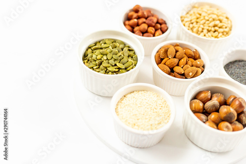 Top View of Variety of Nuts and Seeds on the White Background, Free Space for Text