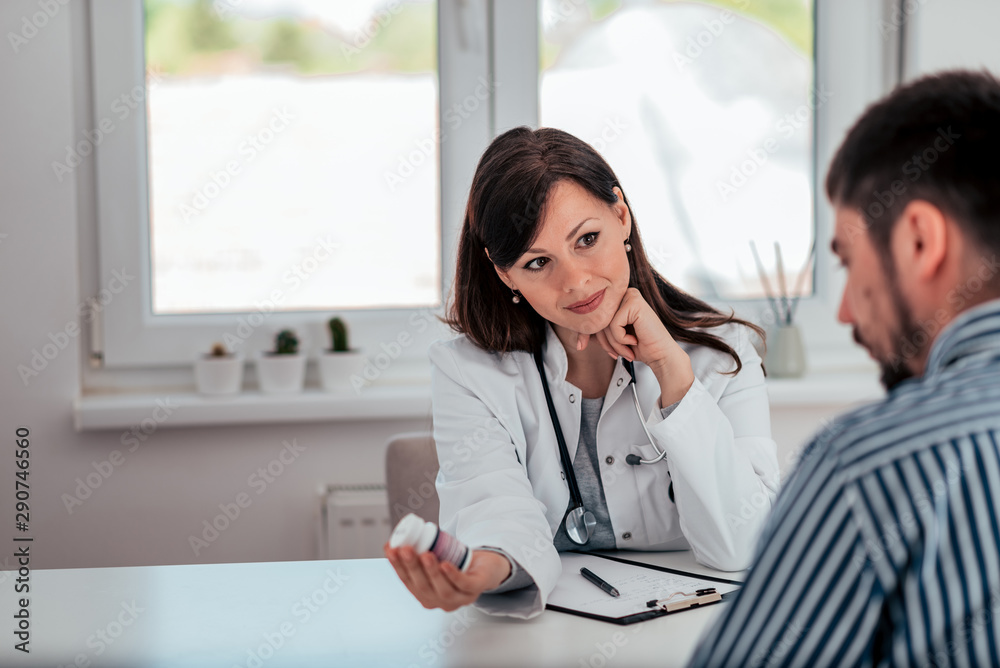 Portrait of doctor talking about medication with a patient in medical office. Portrait of doctor talking about medication with a patient in medical office.
