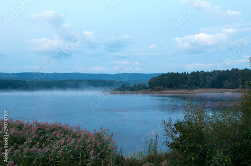 colorful moon on autumn lake at dawn with forest © mikhailgrytsiv