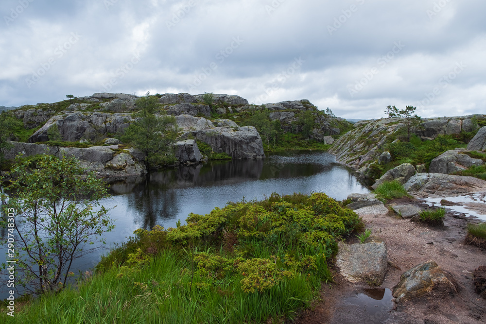 Obraz premium Mountains on the way to the Preachers Pulpit Rock in fjord Lysefjord - Norway - nature and travel background. Lake Tjodnane, july 2019