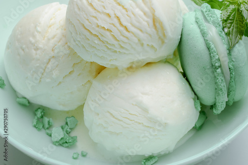 Balls of fresh ice cream with a sprig of mint and mint macaroon.
