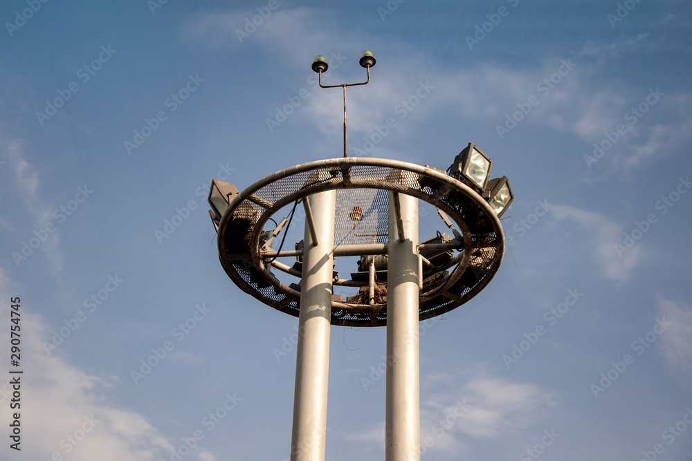 Tower of lighting and equipment at the airport against the blue sky. Engineering systems of the airport and runway. Tower of lighting and equipment at the airport against the blue sky. Engineering systems of the airport and runway.
