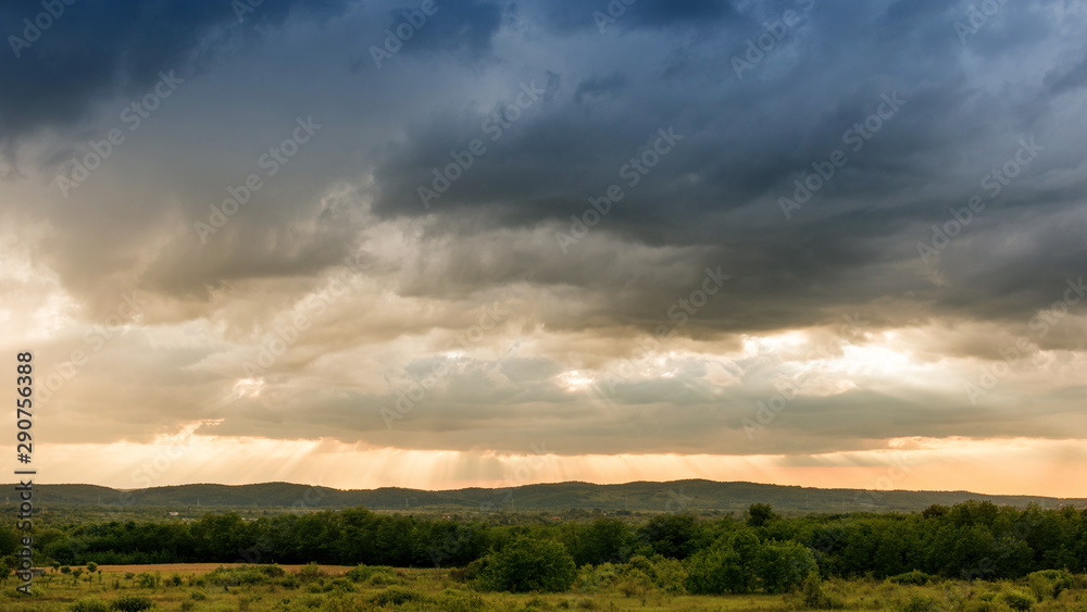Sunrays over golden sunset landscape Sunrays over golden sunset landscape