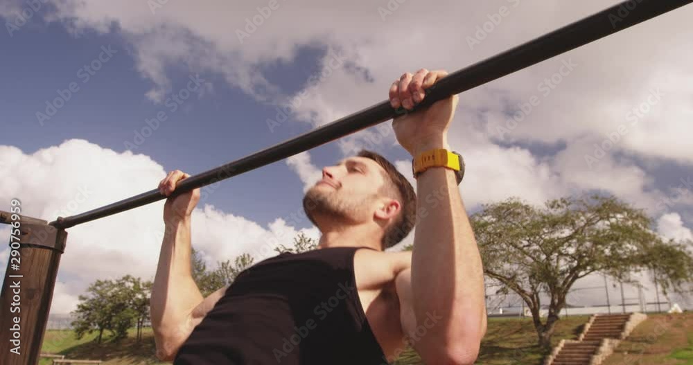 Young man training at an outdoor gym bootcamp Young man training at an outdoor gym bootcamp