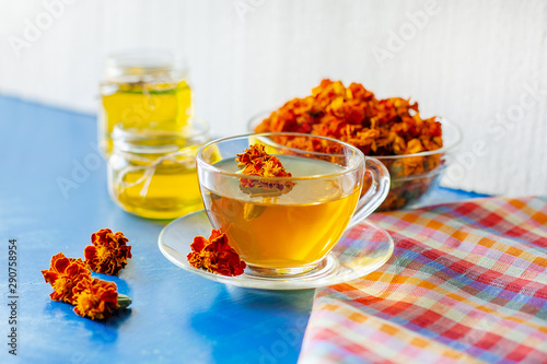 A cup of tea from the flowers of Chernobrivtsov. Processing of dried flowers marigolds. photo