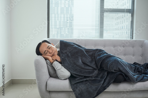Male pensioner sleeping on couch, suffering from high temperature, disease © makistock