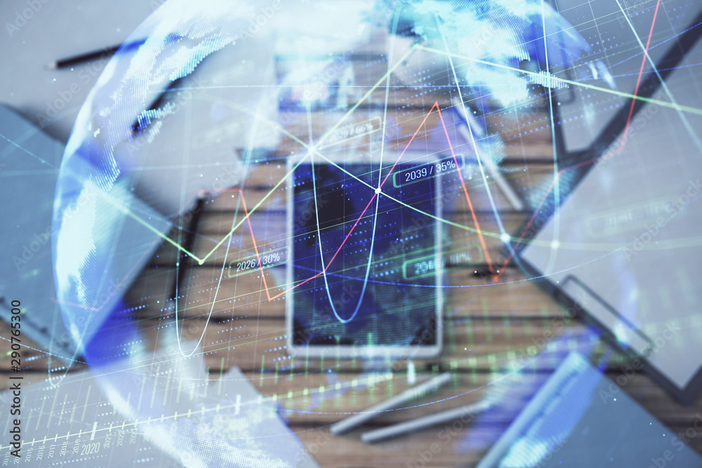 Double exposure of forex chart and world map on digital tablet laying on table background. Concept of market analysis Double exposure of forex chart and world map on digital tablet laying on table background. Concept of market analysis