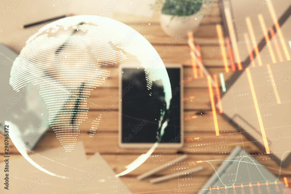 Double exposure of forex chart and world map on digital tablet laying on table background. Concept of market analysis Double exposure of forex chart and world map on digital tablet laying on table background. Concept of market analysis