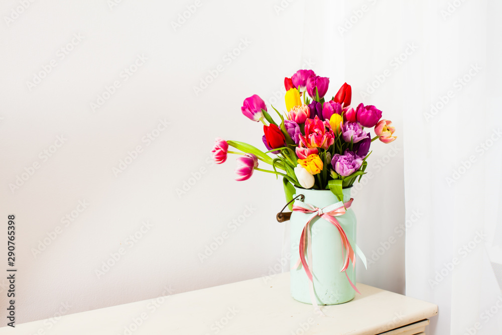Bouquet of colorful tulips in white can Bouquet of colorful tulips in white can