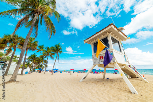 Lifeguard tower and palm trees in Fort Lauderdale shore photo